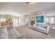 Open-concept living area with fireplace, sofas, and view into kitchen with an island at 3700 Hedge Grove Dr, North Las Vegas, NV 89032