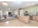 Open concept living room and kitchen area with large television and comfortable seating at 3700 Hedge Grove Dr, North Las Vegas, NV 89032