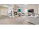 Open living room area with a fireplace, sofa, and large windows for ample natural light at 3700 Hedge Grove Dr, North Las Vegas, NV 89032