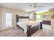 Main bedroom featuring a large bed, ceiling fan, and ensuite bathroom with a tub at 3700 Hedge Grove Dr, North Las Vegas, NV 89032