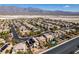 Aerial view showing the community of modern homes, most featuring solar panels, and desert landscaping at 3829 Hawkeye Falls Ave, North Las Vegas, NV 89085