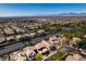 Extensive community with well-kept lawns, landscaping, and greenery, under a bright blue sky at 3829 Hawkeye Falls Ave, North Las Vegas, NV 89085