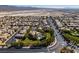 Landscaped community featuring homes with solar panels, lush green lawns, desert landscaping, and a sparkling blue pool at 3829 Hawkeye Falls Ave, North Las Vegas, NV 89085