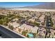 Sprawling neighborhood features well-maintained homes with desert landscaping and solar panels under a bright blue sky at 3829 Hawkeye Falls Ave, North Las Vegas, NV 89085