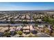 Large community of homes with desert landscaping and views of the city on the horizon under blue skies at 3829 Hawkeye Falls Ave, North Las Vegas, NV 89085