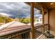 A covered outdoor balcony with ornate metal railing provides views of nearby mountains and trees at 3829 Hawkeye Falls Ave, North Las Vegas, NV 89085