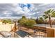 A balcony featuring decorative metal railings offers views of a desert neighborhood and palm trees at 3829 Hawkeye Falls Ave, North Las Vegas, NV 89085