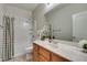 Well-lit bathroom with vanity, large mirror, and shower-tub combo at 3829 Hawkeye Falls Ave, North Las Vegas, NV 89085
