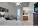 A cozy bedroom with ceiling fan and ensuite bathroom featuring a single sink vanity at 3829 Hawkeye Falls Ave, North Las Vegas, NV 89085