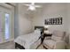 A brightly lit bedroom with ceiling fan, ensuite bathroom, and sliding closet door at 3829 Hawkeye Falls Ave, North Las Vegas, NV 89085