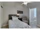 A small bedroom with ensuite bathroom, ceiling fan, and adjacent closet at 3829 Hawkeye Falls Ave, North Las Vegas, NV 89085