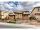 Inviting home featuring a private courtyard entrance, two-car garages, and lovely desert landscaping at 3829 Hawkeye Falls Ave, North Las Vegas, NV 89085