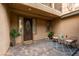 Cozy front porch featuring pavers, sitting area with stylish furniture, and decorative plants at 3829 Hawkeye Falls Ave, North Las Vegas, NV 89085