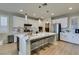Beautiful kitchen with white cabinets, stainless steel appliances, large island and pendant lighting at 3829 Hawkeye Falls Ave, North Las Vegas, NV 89085