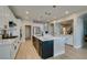 Bright kitchen featuring a large island with seating, white cabinets, and stainless steel appliances at 3829 Hawkeye Falls Ave, North Las Vegas, NV 89085