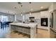Modern kitchen featuring marble island with seating, stylish lighting fixtures, and stainless steel appliances at 3829 Hawkeye Falls Ave, North Las Vegas, NV 89085