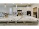 Modern kitchen featuring marble island, stylish lighting fixtures, and stainless steel appliances at 3829 Hawkeye Falls Ave, North Las Vegas, NV 89085