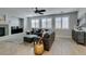 Inviting living room with a cozy fireplace, modern furnishings, and ample natural light through shuttered windows at 3829 Hawkeye Falls Ave, North Las Vegas, NV 89085