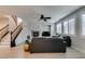 Bright living room with wood floors, staircase, ceiling fan, and gas fireplace provides an inviting space at 3829 Hawkeye Falls Ave, North Las Vegas, NV 89085