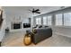 Comfortable living room features wood floors, plantation shutters, ceiling fan and a cozy fireplace at 3829 Hawkeye Falls Ave, North Las Vegas, NV 89085