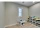 This cozy ' room features a window with shutters and a neutral color palette at 3829 Hawkeye Falls Ave, North Las Vegas, NV 89085