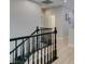 Classic staircase with black banister and natural light streaming through nearby windows at 3829 Hawkeye Falls Ave, North Las Vegas, NV 89085