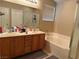 Bathroom featuring double sinks, bathtub and shower and a window at 3844 Hollycroft Dr, North Las Vegas, NV 89081