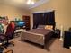 Comfortable bedroom with ceiling light, dark curtains and carpet at 3844 Hollycroft Dr, North Las Vegas, NV 89081