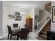Dining room with a glass table, neutral paint, and a carpeted staircase at 3844 Hollycroft Dr, North Las Vegas, NV 89081