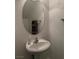 Half bathroom with a pedestal sink and an oval mirror at 3844 Hollycroft Dr, North Las Vegas, NV 89081