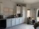 Bright kitchen featuring white cabinets, modern appliances and tiled floors at 3844 Hollycroft Dr, North Las Vegas, NV 89081