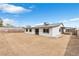 View of the house from the large backyard, with fresh landscaping potential at 3911 Chutney St, Las Vegas, NV 89121