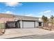 Charming single-story home with a two-car garage and gated drive, set against a bright blue sky at 3911 Chutney St, Las Vegas, NV 89121