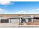 Inviting home exterior with a two-car garage, small garden, and unique arched entrance, perfect for curb appeal at 3911 Chutney St, Las Vegas, NV 89121