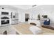 Open kitchen and living room area with stainless steel appliances and white cabinets at 3911 Chutney St, Las Vegas, NV 89121