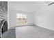 Bright living room featuring a gray brick fireplace, a window, and a door at 3911 Chutney St, Las Vegas, NV 89121