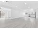 Bright living room with sleek floors leading into the kitchen and hallways at 3911 Chutney St, Las Vegas, NV 89121