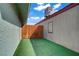 Cozy backyard area features artificial grass and wood fence, perfect for outdoor enjoyment at 4156 Broadriver Dr, Las Vegas, NV 89108