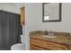 This bathroom features a shower/tub combo with granite countertops and wood cabinets at 4156 Broadriver Dr, Las Vegas, NV 89108