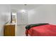 Bedroom with a bed with red blanket and a glimpse into an attached bathroom at 4156 Broadriver Dr, Las Vegas, NV 89108