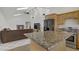 Open kitchen and living area boasts granite counters, stainless steel appliances, vaulted ceilings, and skylights at 4156 Broadriver Dr, Las Vegas, NV 89108