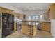 Bright kitchen featuring an island, granite countertops, and a bay window for natural light at 4156 Broadriver Dr, Las Vegas, NV 89108