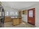 Bright kitchen showcases wood cabinets, granite countertops, a central island with wine rack, and direct access to the outside at 4156 Broadriver Dr, Las Vegas, NV 89108