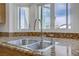 Kitchen sink area features stainless steel sink with granite countertop and large bay window for ample natural light at 4156 Broadriver Dr, Las Vegas, NV 89108