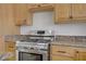 Close-up shot of the kitchen features stainless steel oven and range with granite countertops and wood cabinets at 4156 Broadriver Dr, Las Vegas, NV 89108