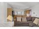 Living room with kitchen view featuring a brown sectional sofa and tile flooring at 4156 Broadriver Dr, Las Vegas, NV 89108