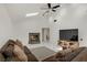 Spacious living room includes a brick fireplace, tile flooring, vaulted ceilings, and natural lighting at 4156 Broadriver Dr, Las Vegas, NV 89108