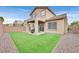Backyard features manicured lawn, patio, and privacy fence making it an ideal space for outdoor enjoyment at 4224 Galapagos Ave, North Las Vegas, NV 89084