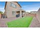 Landscaped backyard has lawn, a covered patio, grill, and privacy fence offering a private outdoor space at 4224 Galapagos Ave, North Las Vegas, NV 89084