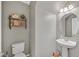 Cozy powder room featuring a pedestal sink, decorative shelves, and neutral wall color at 4224 Galapagos Ave, North Las Vegas, NV 89084